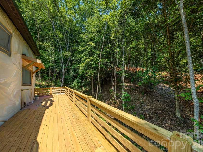 119 Catatoga Trail, Marion, NC 83452.  MLS# CAR4403608, YatesRealty ID 46557. Expansive deck overlooking wooded setting