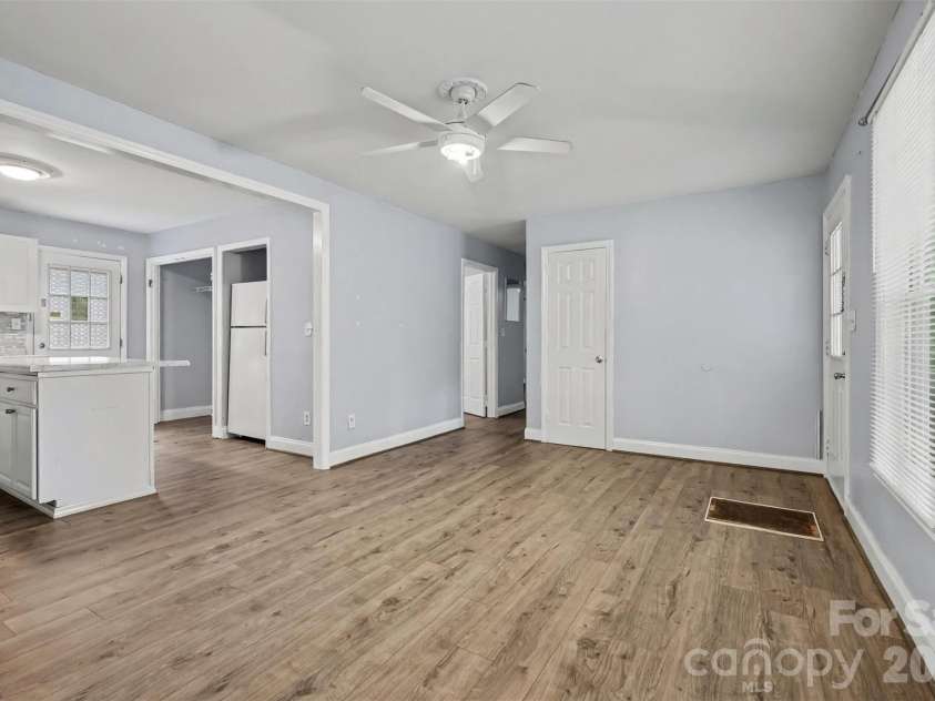 802 Stowe Drive, Lowell, NC 28098.  MLS# CAR4417684, YatesRealty ID 46559. Living room and kitchen flow together