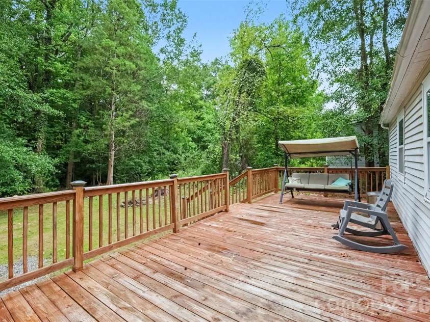 802 Stowe Drive, Lowell, NC 28098.  MLS# CAR4417684, YatesRealty ID 46559. Rocking chair back deck