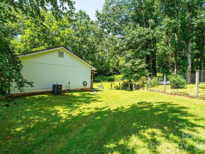 570 Flat Creek Valley Road, Lake Toxaway, NC 28747.  MLS# CAR4416431, YatesRealty ID 46565. Side yard