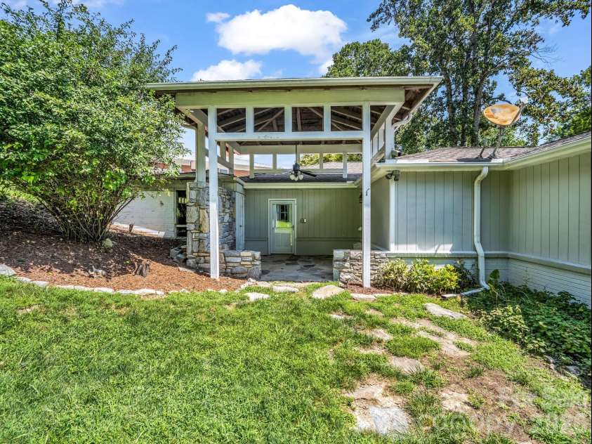 370 Orchard Circle, Laurel Park, NC 28739.  MLS# CAR4416531, YatesRealty ID 46572. Covered patio off primary ensuite