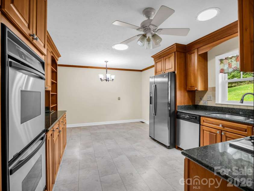 370 Orchard Circle, Laurel Park, NC 28739.  MLS# CAR4416531, YatesRealty ID 46572. Kitchen with new tile flooring