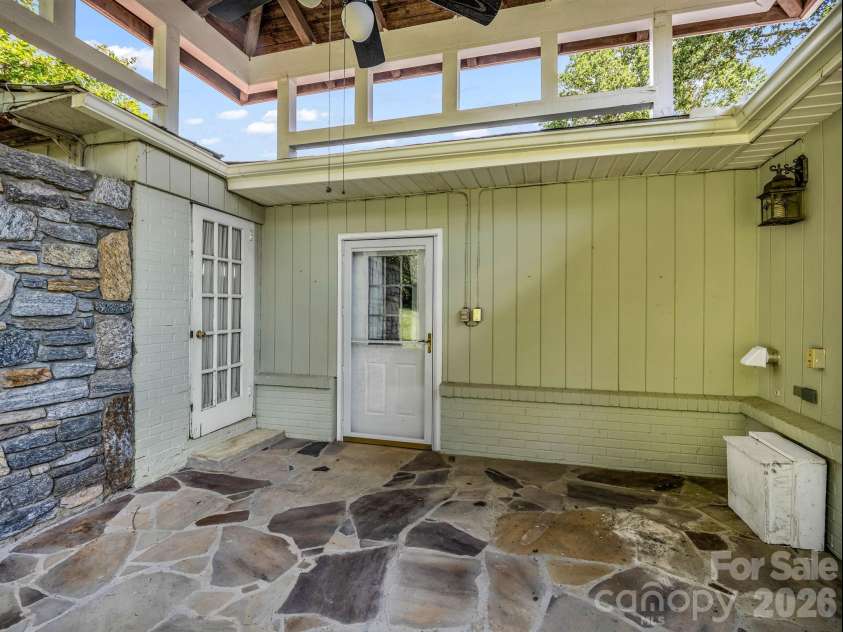 370 Orchard Circle, Laurel Park, NC 28739.  MLS# CAR4416531, YatesRealty ID 46572. Patio has stone flooring and charm!