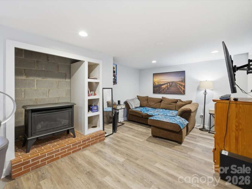 109 Elk Court, Mount Holly, NC 28120.  MLS# CAR4344317, YatesRealty ID 4662. Living room area with gas stove in basement (2nd living area)