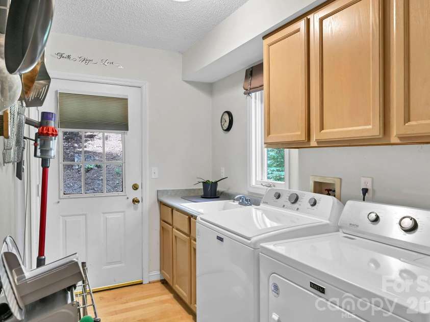 25 Weston Heights Drive, Asheville, NC 28803.  MLS# CAR4417799, YatesRealty ID 46650. Laundry room with outside exit to deck