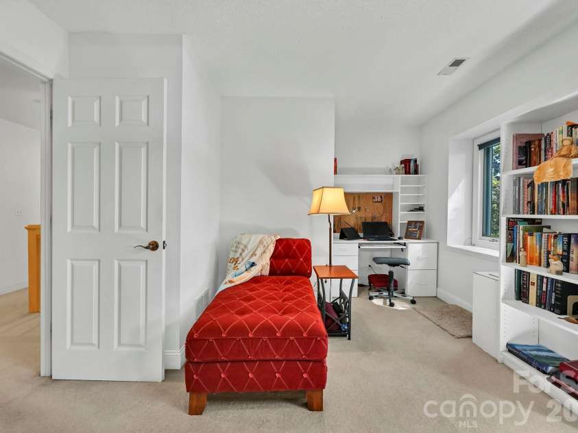 25 Weston Heights Drive, Asheville, NC 28803.  MLS# CAR4417799, YatesRealty ID 46650. Reading by the window
