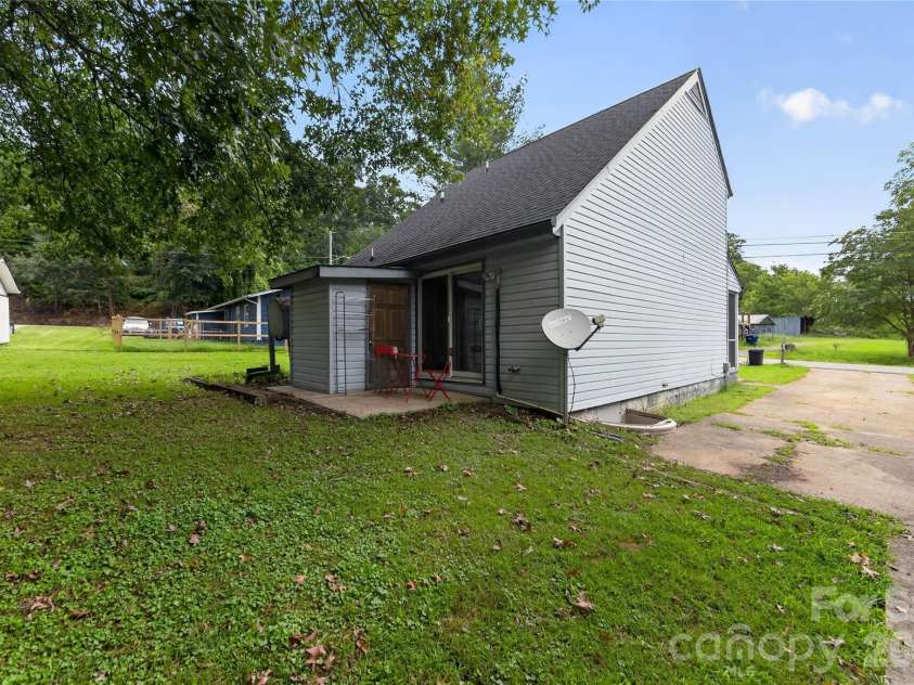 131 Spencer Street, Clyde, NC 28721.  MLS# CAR4417558, YatesRealty ID 46666. Back of home with patio -