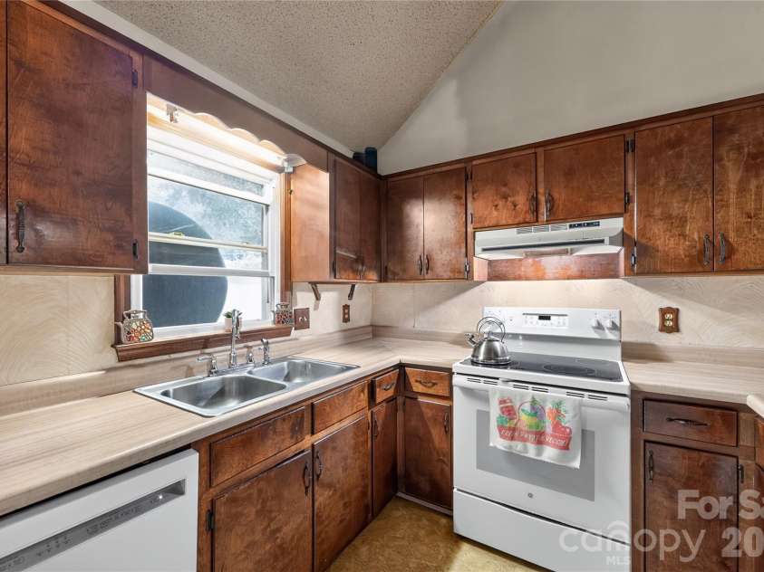 131 Spencer Street, Clyde, NC 28721.  MLS# CAR4417558, YatesRealty ID 46666. Kitchen and the potential is exciting!