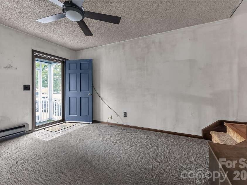 131 Spencer Street, Clyde, NC 28721.  MLS# CAR4417558, YatesRealty ID 46666. Living room- I have resources to help do everything.