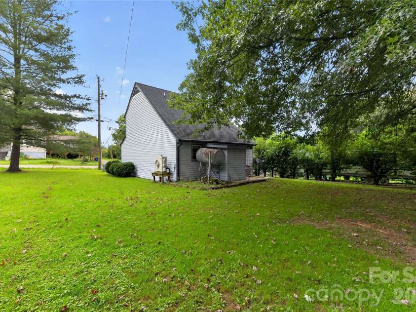 131 Spencer Street, Clyde, NC 28721.  MLS# CAR4417558, YatesRealty ID 46666. Note the lovely oak tree!