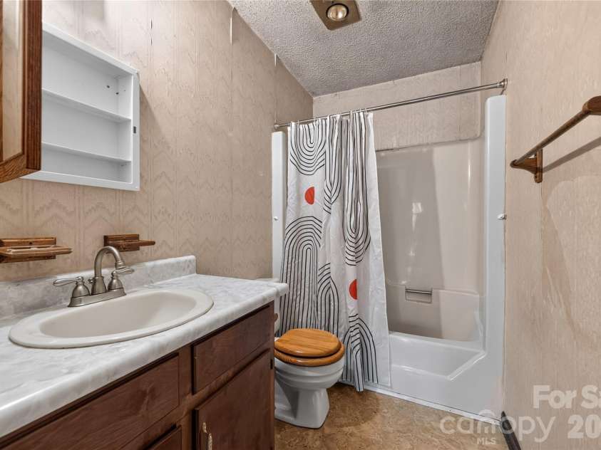 131 Spencer Street, Clyde, NC 28721.  MLS# CAR4417558, YatesRealty ID 46666. Primary bathroom - does it need to be redone? Absolutley, and you are creative.