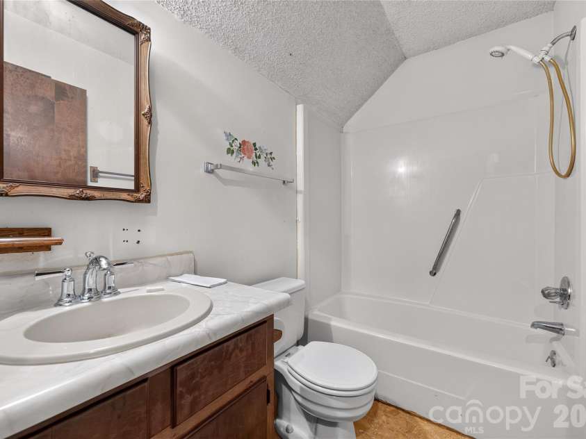 131 Spencer Street, Clyde, NC 28721.  MLS# CAR4417558, YatesRealty ID 46666. Up the stairs, full bath ready for your creativie reno.
