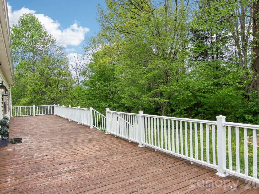 165 Sequoyah Drive, Waynesville, NC 28785.  MLS# CAR4346043, YatesRealty ID 4667. An expansive deck offering serene wooded privacy