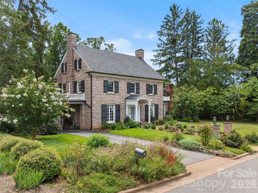 14 Griffing Boulevard, Asheville, NC 28804.  MLS# CAR4413603, YatesRealty ID 46721. Beautifully landscaped grounds frame the historic stone home.