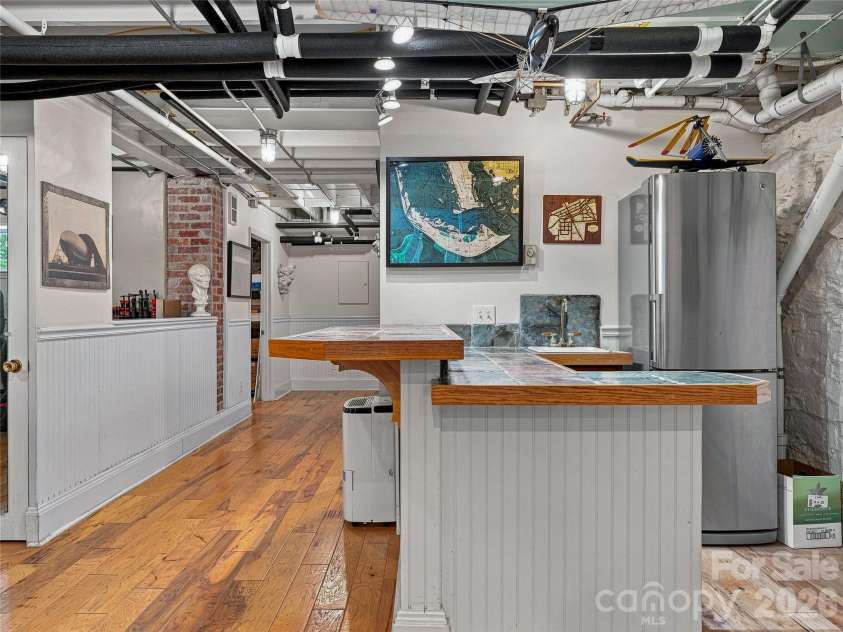 14 Griffing Boulevard, Asheville, NC 28804.  MLS# CAR4413603, YatesRealty ID 46721. Lower level gathering space with refrigerator and sink!