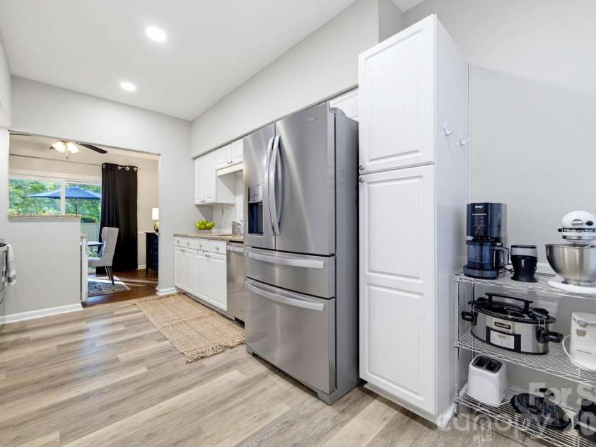 5901 Quail Hollow Road, Charlotte, NC 28210.  MLS# CAR4430297, YatesRealty ID 46771. Additional kitchen view highlighting generous storage, including full-height pantry cabinetry with convenient pull-out shelving to maximize storage and accessibility