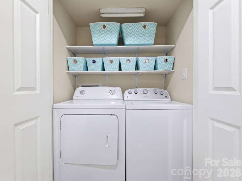 5901 Quail Hollow Road, Charlotte, NC 28210.  MLS# CAR4430297, YatesRealty ID 46771. Full-size enclosed laundry area, with added shelving for storage