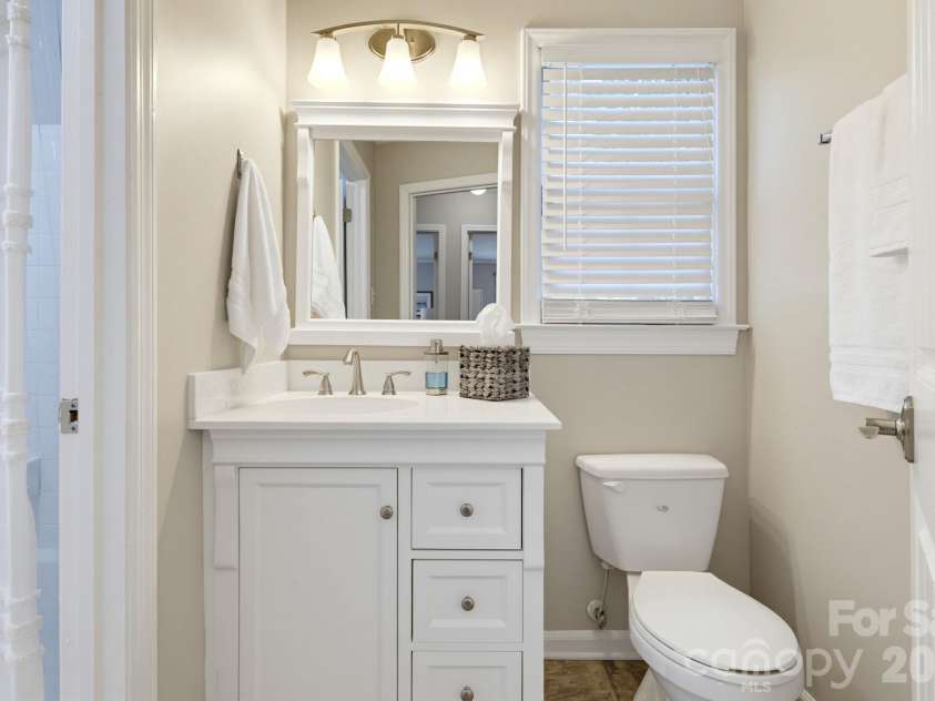5901 Quail Hollow Road, Charlotte, NC 28210.  MLS# CAR4430297, YatesRealty ID 46771. New guest bath vanity with storage, also with updated fixtures.