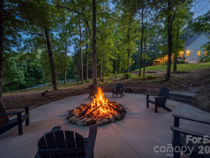 340 Whippoorwill Lane, Mount Holly, NC 28120.  MLS# CAR4417978, YatesRealty ID 46788. Firepit between house and stables/barn
