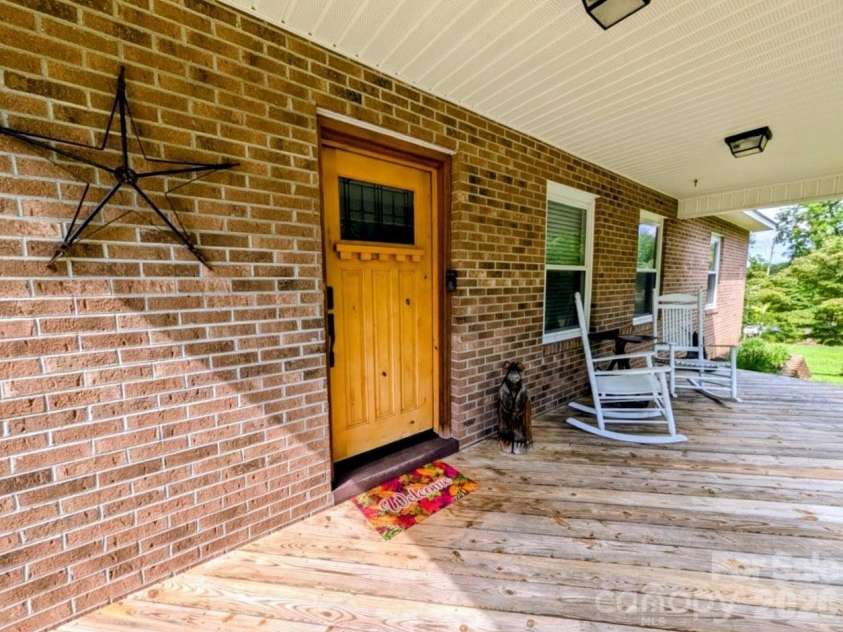 213 Rustling Pines Drive, Hendersonville, NC 28792.  MLS# CAR4418354, YatesRealty ID 46806. Rocking Chair porch