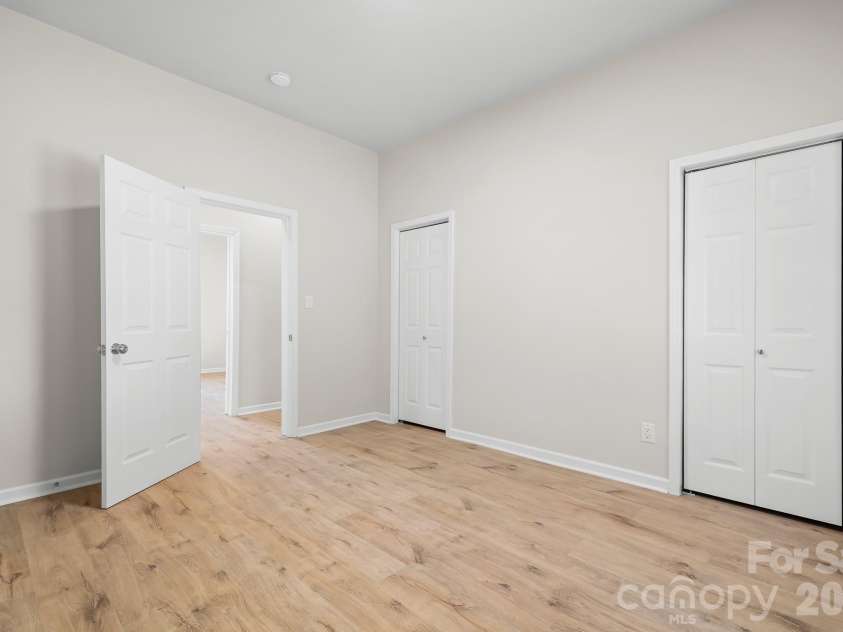 104 1st Avenue, China Grove, NC 28023.  MLS# CAR4418382, YatesRealty ID 46813. Spacious primary bedroom with two closets.
