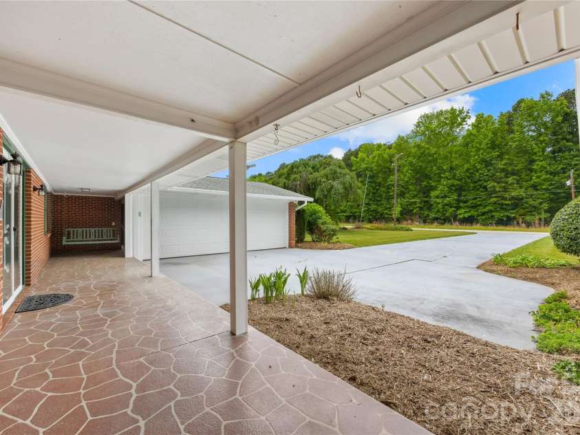 2570 Lentz Road, China Grove, NC 28023.  MLS# CAR4385487, YatesRealty ID 4682. Large rocking-chair front porch
