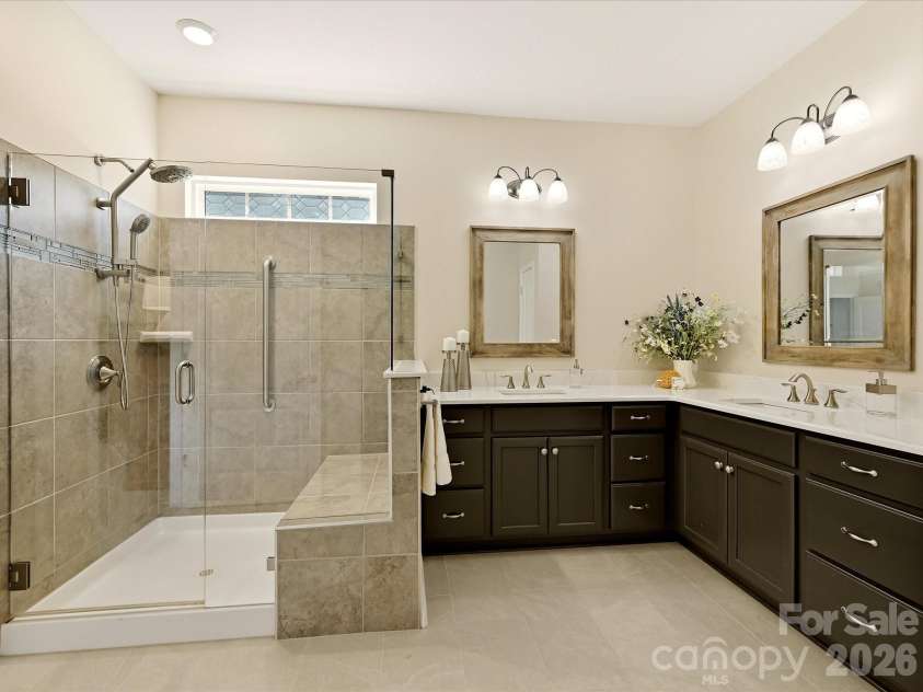 5060 Big Bend Drive, Lancaster, SC 29720.  MLS# CAR4414688, YatesRealty ID 46826. HEATED TILED FLOORS in Primary Bath! Quartz Counters, Framed Mirrors, Painted Cabinets, Shower w/ Frameless Shower Door, Tiled Surround, Grab Bars, Bench Seat and Upgraded Shower Attachment