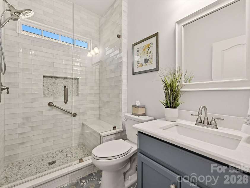 5060 Big Bend Drive, Lancaster, SC 29720.  MLS# CAR4414688, YatesRealty ID 46826. Remodeled Full Bath 2 w/ Designer Tiled Surround & Flooring, New Showerhead system, Custom Tiled Niche, Farmeless Door, New Tiled Flooring, Framed Mirrors, Single bowl sink on Quartz Coutner, and Painted Cabinet