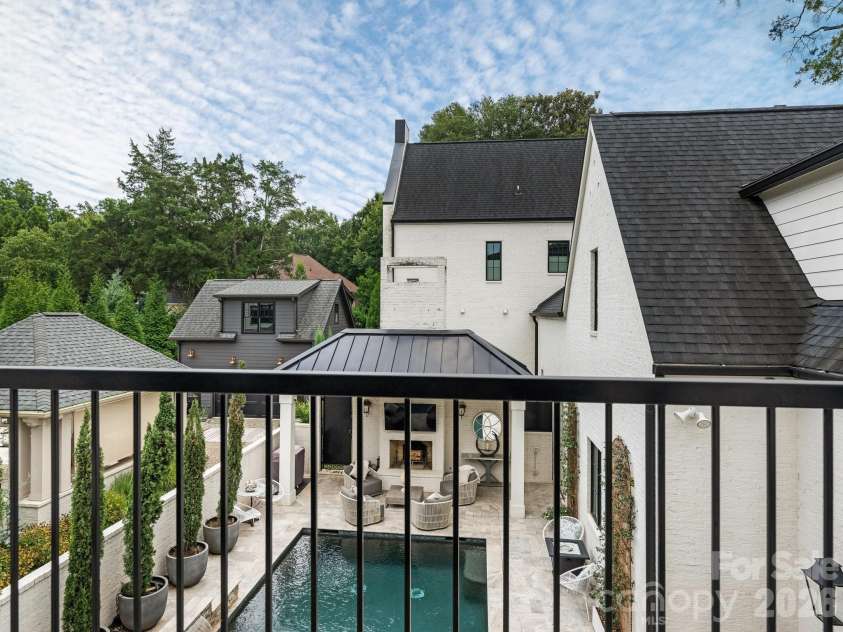 1202 Townes Road, Charlotte, NC 28209.  MLS# CAR4416588, YatesRealty ID 46834. Balcony from Primary overlooking Pool and Courtyard