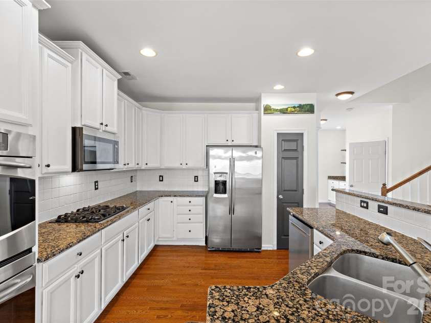 7600 Turley Ridge Lane, Charlotte, NC 28273.  MLS# CAR4413385, YatesRealty ID 46876. Beautiful stone backsplash and pantry.