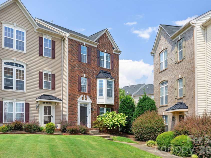 7600 Turley Ridge Lane, Charlotte, NC 28273.  MLS# CAR4413385, YatesRealty ID 46876. Red brick end unit with large community lawn in front.