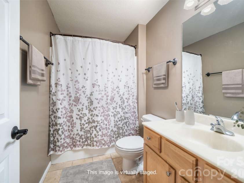 151 Willard Lane, Hendersonville, NC 28792.  MLS# CAR4281738, YatesRealty ID 4690. Full bath for first two bedrooms and guests - virtually staged