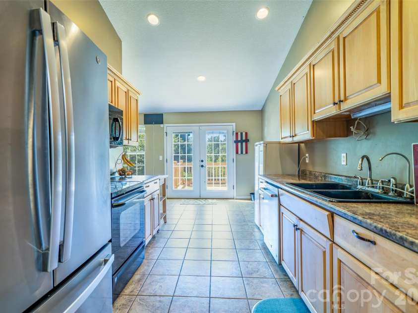 151 Willard Lane, Hendersonville, NC 28792.  MLS# CAR4281738, YatesRealty ID 4690. Kitchen with doors to the deck