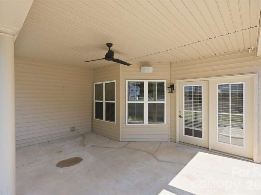 593 Harrison Drive, Concord, NC 28027.  MLS# CAR4413836, YatesRealty ID 46904. Extended covered patio with ceiling fan accessed from kitchen