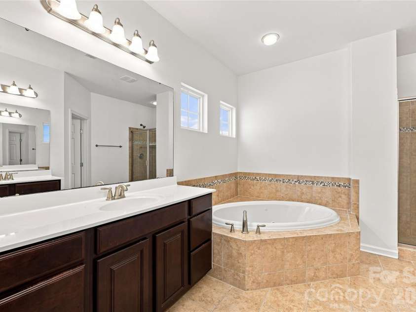 593 Harrison Drive, Concord, NC 28027.  MLS# CAR4413836, YatesRealty ID 46904. Primary bathroom with double sinks, jetted tub and separate shower
