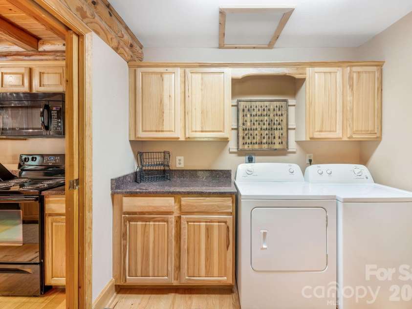 175 Big Rock Road, Bostic, NC 28018.  MLS# CAR4416989, YatesRealty ID 46907. Convenient laundry/mudroom just off the kitchen features a full-size washer and dryer, abundant cabinetry, counter space, and additional storage.
