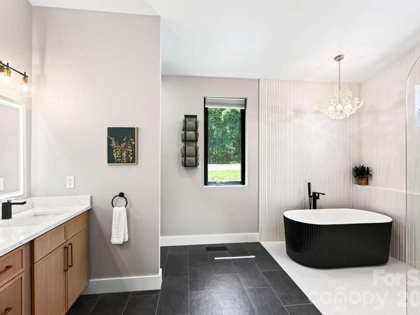 75 Boone Trail, Weaverville, NC 28787.  MLS# CAR4417076, YatesRealty ID 46979. Spa-like primary bath features soaking tub, double vanity, and zero entry shower