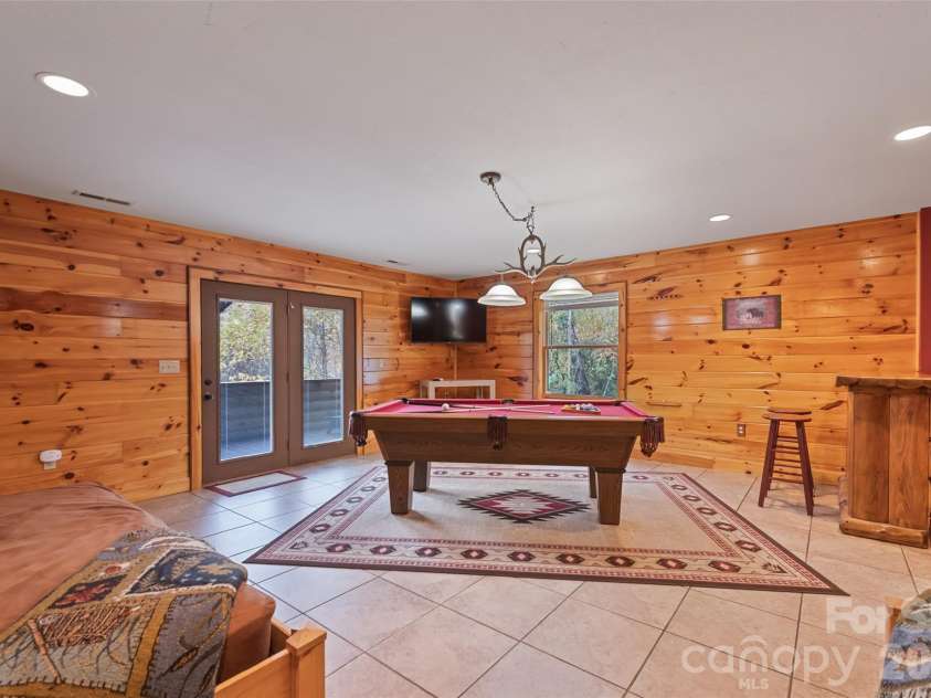 235 Soaring Eagle Road, Bryson City, NC 28713.  MLS# CAR4316418, YatesRealty ID 4698. Durable tile floors, cabin decor and access to screened porch 