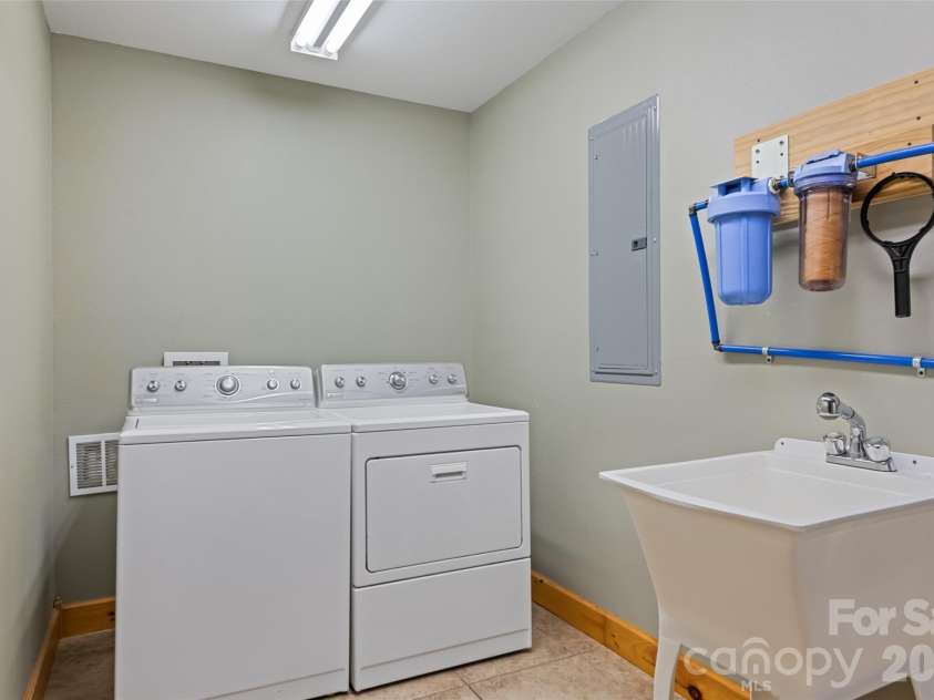 235 Soaring Eagle Road, Bryson City, NC 28713.  MLS# CAR4316418, YatesRealty ID 4698. Laundry room with included washer and dryer and utility sink
