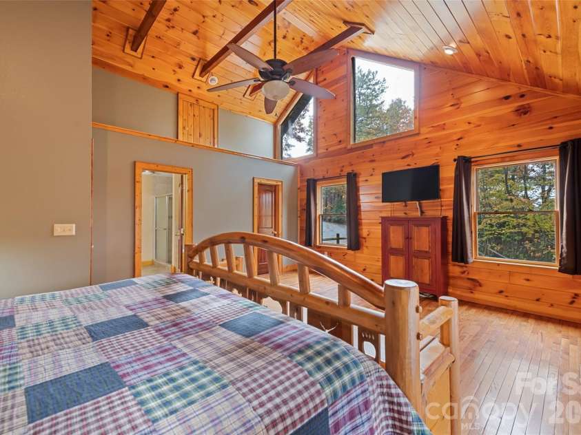 235 Soaring Eagle Road, Bryson City, NC 28713.  MLS# CAR4316418, YatesRealty ID 4698. Primary suite with incredible natural light through gable windows and extra loft storage