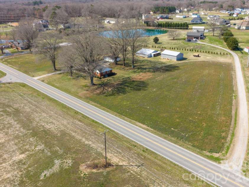 5803 Morgan Mill Road, Monroe, NC 28110.  MLS# CAR4352818, YatesRealty ID 4698. Fields on both side of home