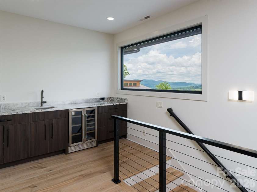 24 Watchman Drive, Hendersonville, NC 28791.  MLS# CAR4215455, YatesRealty ID 4699. Upstairs Granite Wet bar at top of stairs
