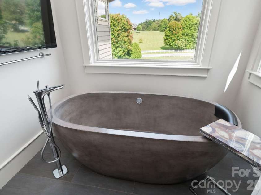 31 Bradford Vistas Drive, Fletcher, NC 28732.  MLS# CAR4303470, YatesRealty ID 4703. Unique soaking tub with amazing views in primary bathroom suite