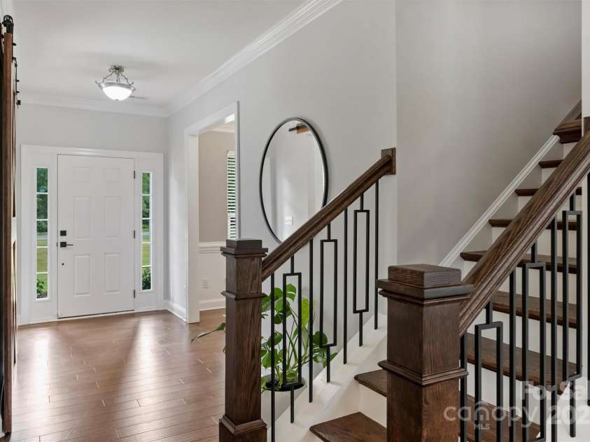 8011 Caliterra Drive, Charlotte, NC 28227.  MLS# CAR4241034, YatesRealty ID 4703. Beautiful Wood and Iron Staircase