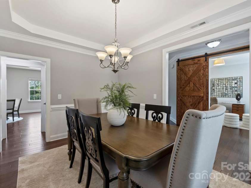 8011 Caliterra Drive, Charlotte, NC 28227.  MLS# CAR4241034, YatesRealty ID 4703. Dining space with view of Barn door to office