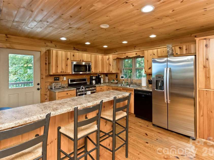 153 Tall Oaks Drive, Maggie Valley, NC 28751.  MLS# CAR4418740, YatesRealty ID 47031. Kitchen features cool island/breakfast bar.