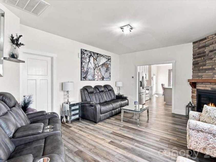 15 Hyde Park Place, Arden, NC 28704.  MLS# CAR4416533, YatesRealty ID 47055. Bright living room with stone fireplace