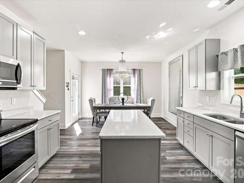 15 Hyde Park Place, Arden, NC 28704.  MLS# CAR4416533, YatesRealty ID 47055. Gorgeous countertops throughout the entire kitchen. Pantry in the left corner