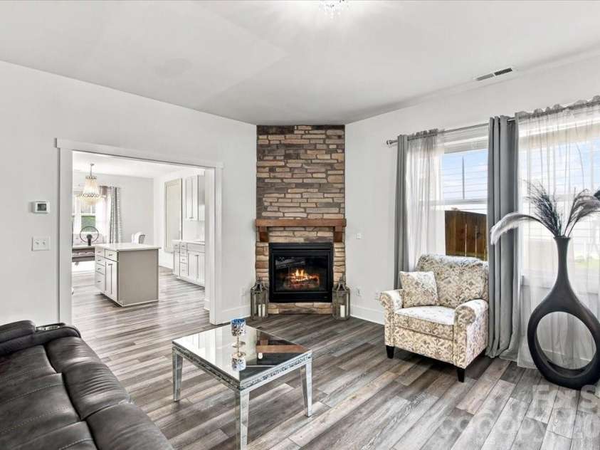 15 Hyde Park Place, Arden, NC 28704.  MLS# CAR4416533, YatesRealty ID 47055. Living room with stone stacked gas log fireplace