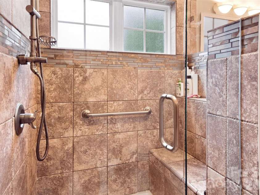 439 Glencrest Drive, Stanley, NC 28164.  MLS# CAR4415116, YatesRealty ID 47073. Stall Shower is tiled with glass door.